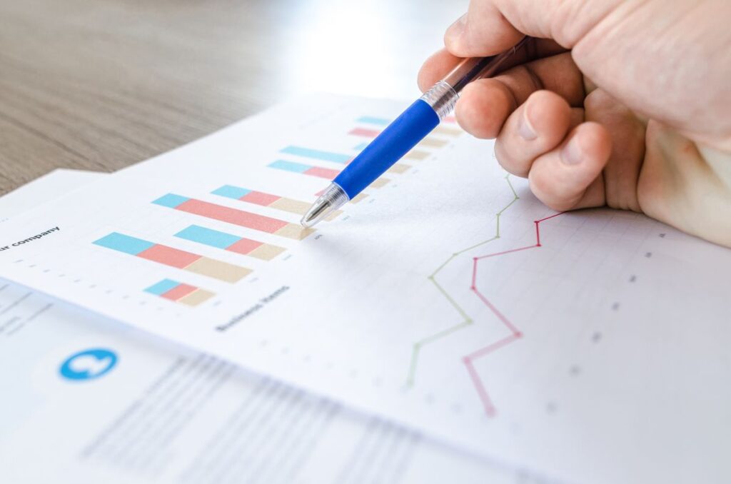 Reviewing a project progress chart during a controls meeting